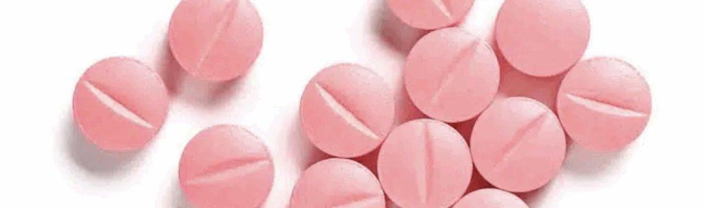 Pink round Bromazepam (Lectopam) tablets with score lines, used short-term for treating anxiety and tension.